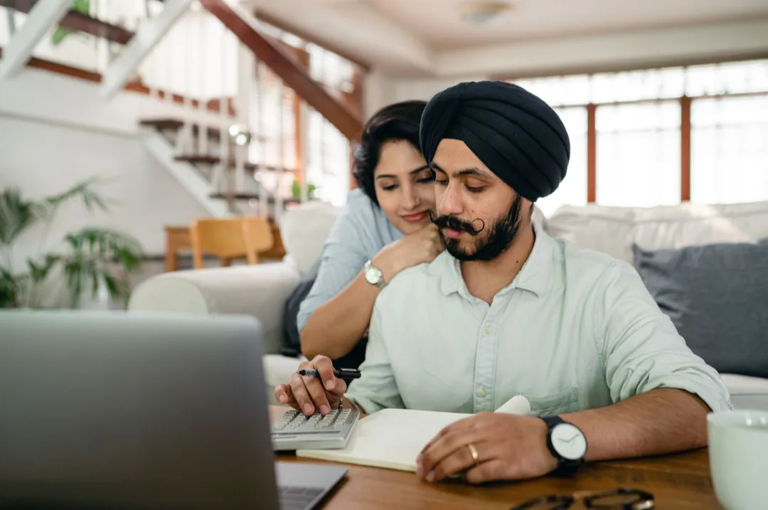 Couple calmly reviewing their finances together at home