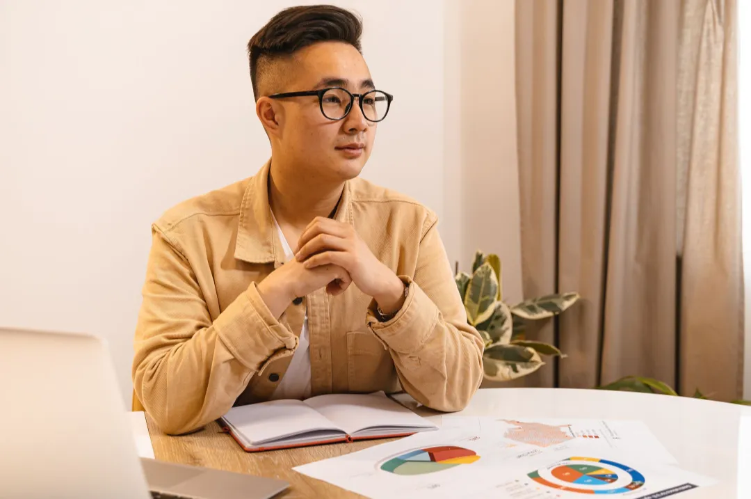 Young professional reviewing his savings and investment plan at a desk